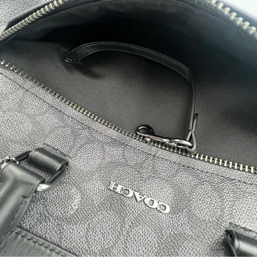Coach Slim Brief In Signature Canvas With Trolley Sleeve